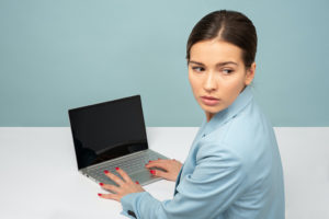 nervous woman with laptop compromising wordpress website security.