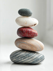 colorful balanced rocks show balance between web design investment and results